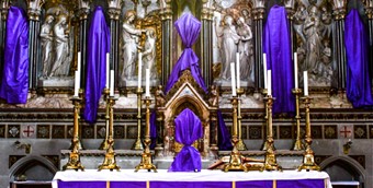 Altar with Purple Cloths Covering Religious Statues