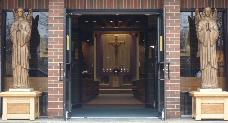 Front Entrance to St. Clement Church - Doors are Open, Altar is Visible, Doors are flanked by Statues of Angels
