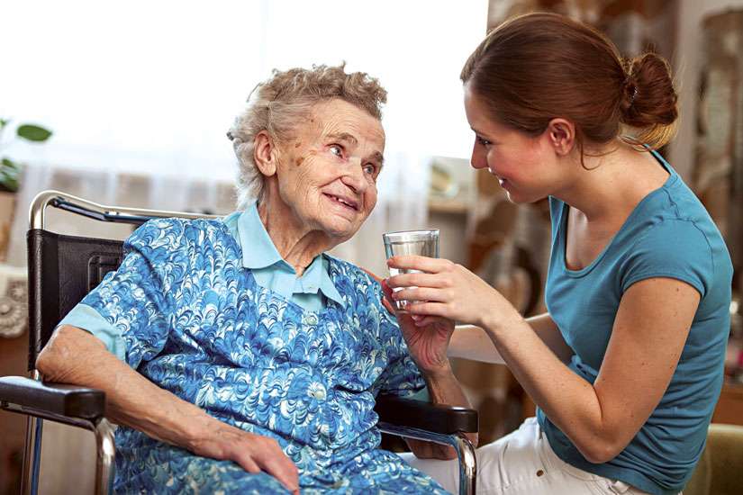 Young Woman Helping Elderly Woman