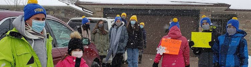 CNOY - Coldest Night of the Year 2022 - People dressed warmly standing outside in snow